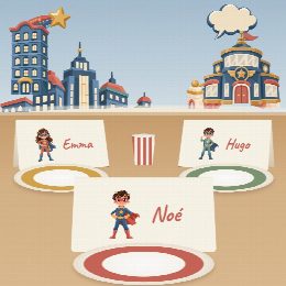Porte-prénoms super-héros à imprimer, pliés et posés sur la table de fête devant les assiettes, au prénom de chaque invité(e)