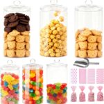 Bocaux en verre d'un candy bar garnis de bonbons, biscuits et popcorn, avec pelle et sachets à friandises