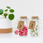 Mini-bouteilles en verre à bouchon de liège remplies de bonbons, avec étiquette kraft au prénom de l'invité